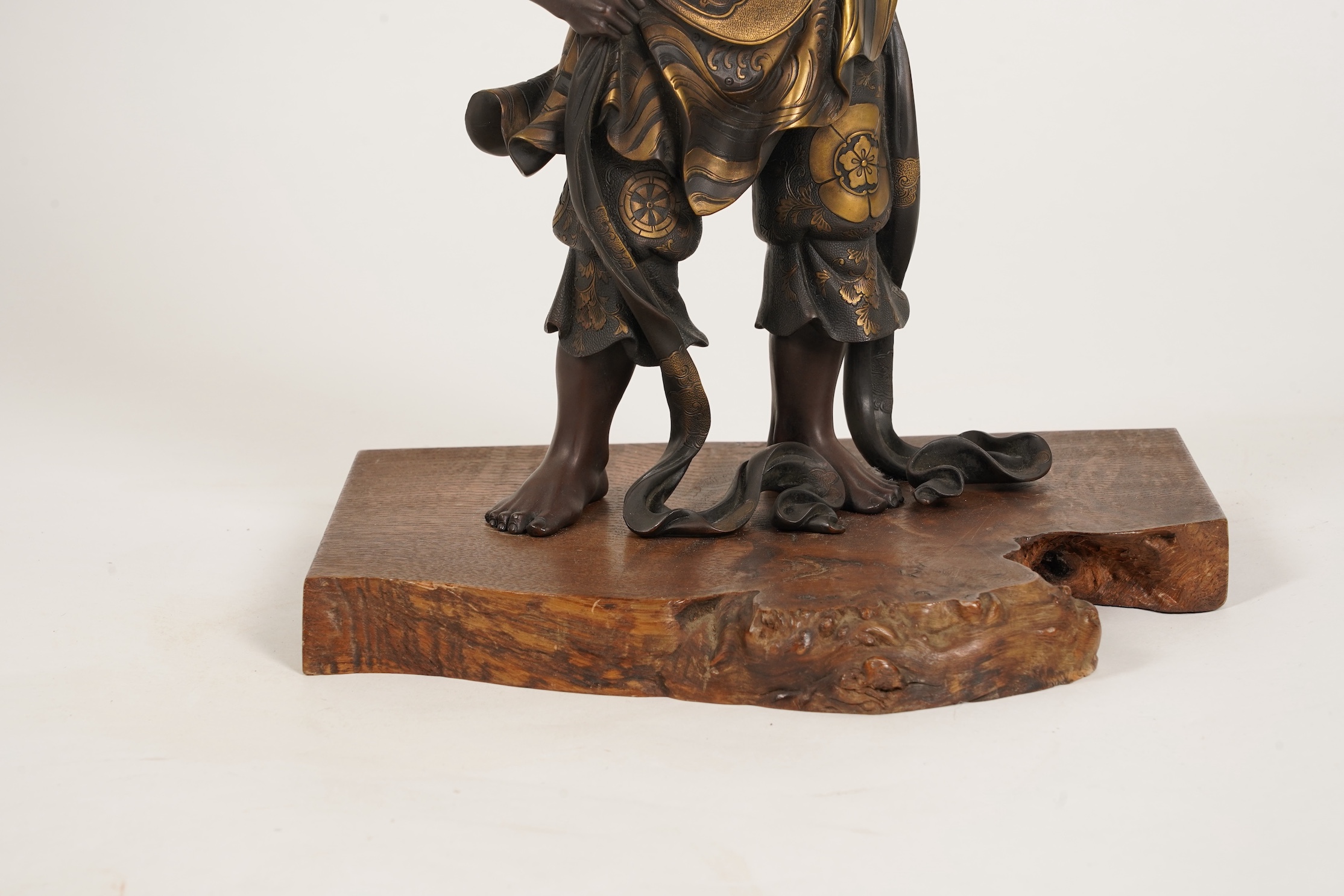 A large Japanese Miyao style parcel gilt bronze figure holding a koro aloft, 20th century